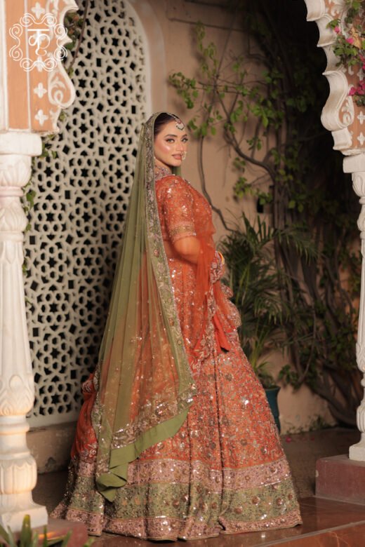 Luxury rust orange wedding lehenga set with coordinated blouse