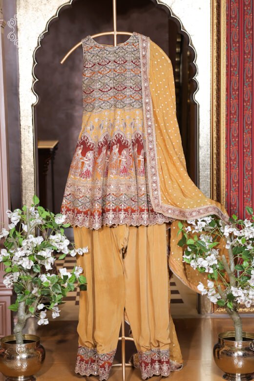 Elegant mustard yellow ethnic suit featuring intricate embroidery
