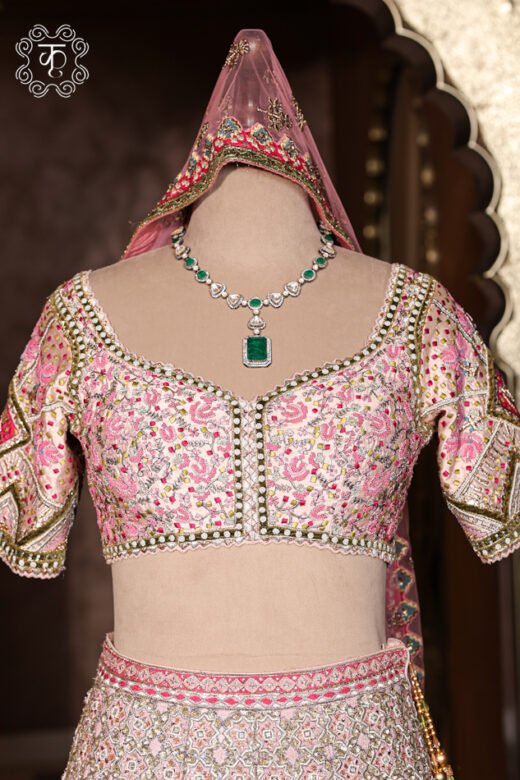 Close-up of the hand-embroidered sweetheart neckline blouse with chevron sleeve details from the Hand Embroidered Heavy Bridal Lehenga Choli Set.