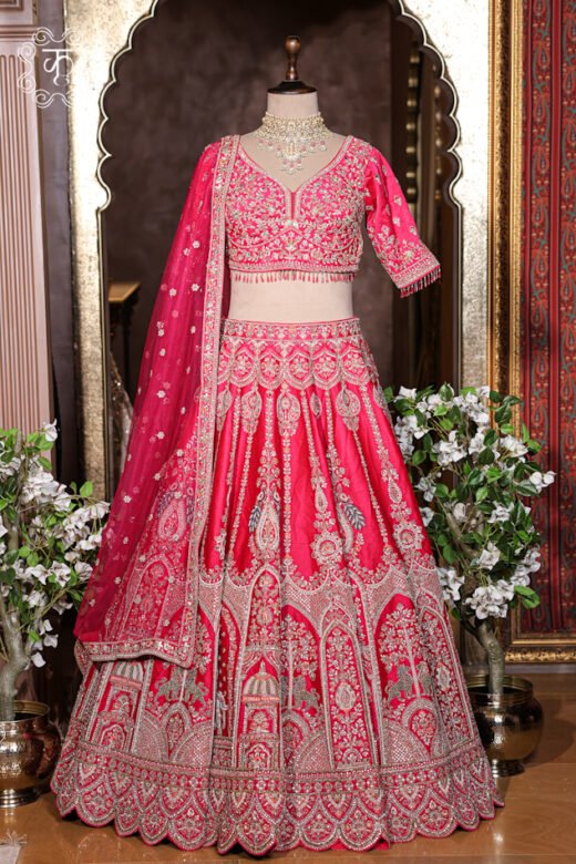 Detailed view of the hand-embroidered sweetheart neckline blouse with hanging bead fringe details from the Hand Embroidered Heavy Bridal Lehenga Choli Set.