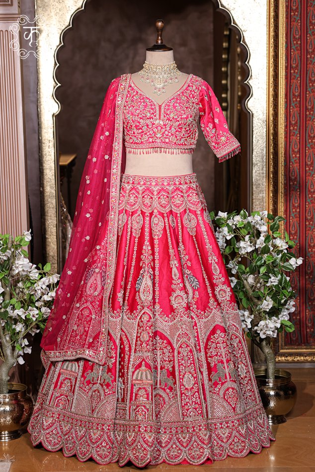 Detailed view of the hand-embroidered sweetheart neckline blouse with hanging bead fringe details from the Hand Embroidered Heavy Bridal Lehenga Choli Set.