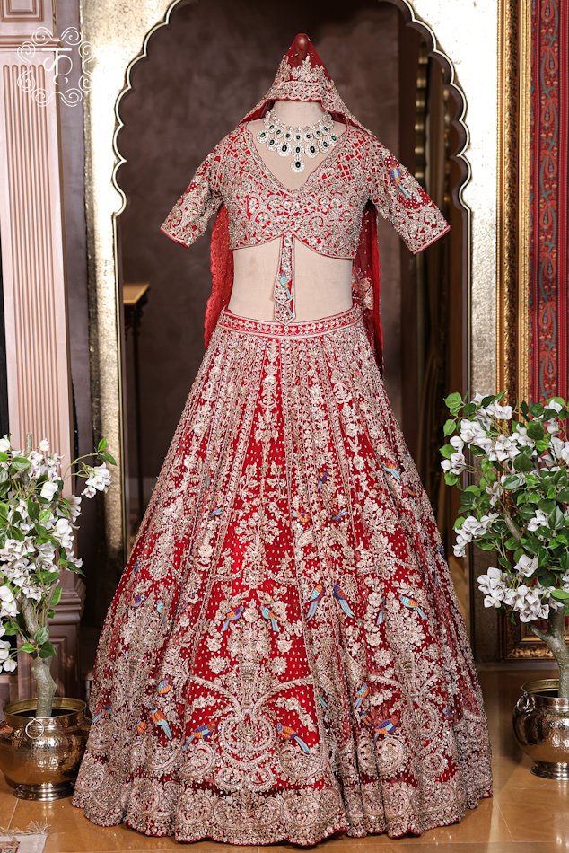 Hand Embroidered Heavy Bridal Lehenga Choli Set featuring an intricately embellished V-neck choli, a flared skirt with bird motif zardozi embroidery, and a matching net dupatta from Kridhaa.