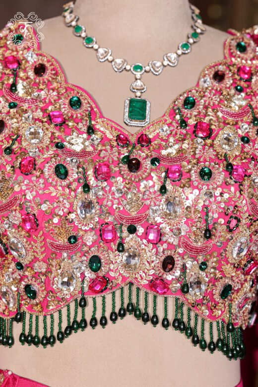 Close-up of the multi-colored stone embroidery and hanging beaded tassel fringes on the Hand Embroidered Stone Work Designer Lehenga Choli Set blouse.