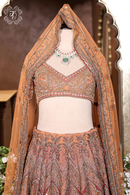 Hand Embroidered Heavy Bridal Lehenga Choli Set featuring an intricately embellished sweetheart-neck choli, a flared chevron and medallion motif skirt, and a matching net dupatta from Kridhaa.