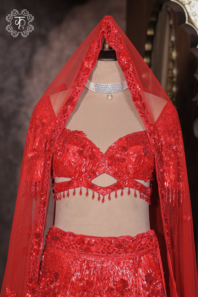 Detailed view of the cut-out keyhole sweetheart blouse with sequin embellishments and bead fringes from the Hand Embroidered Sequin and 3D Floral Bridal Lehenga Choli Set.
