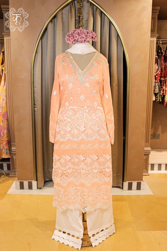 Detailed view of the scalloped cutwork border on the palazzo trousers of the Hand Embroidered Chikankari and Schiffli Cutwork Suit Set.