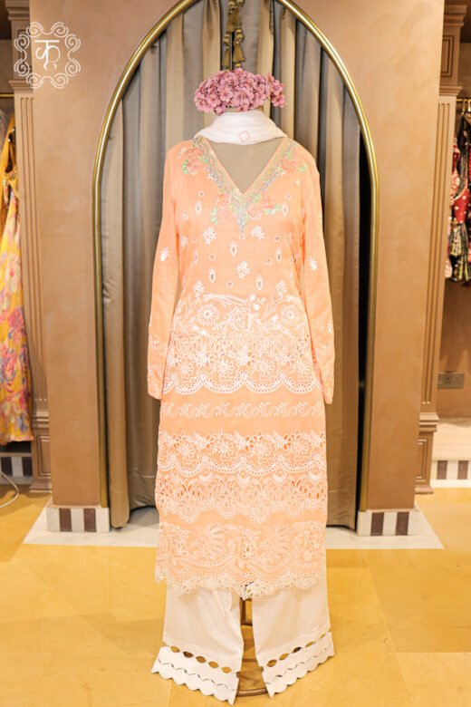 Close-up of the tiered schiffli cutwork lace and embroidered borders on the Hand Embroidered Chikankari and Schiffli Cutwork Suit Set tunic.