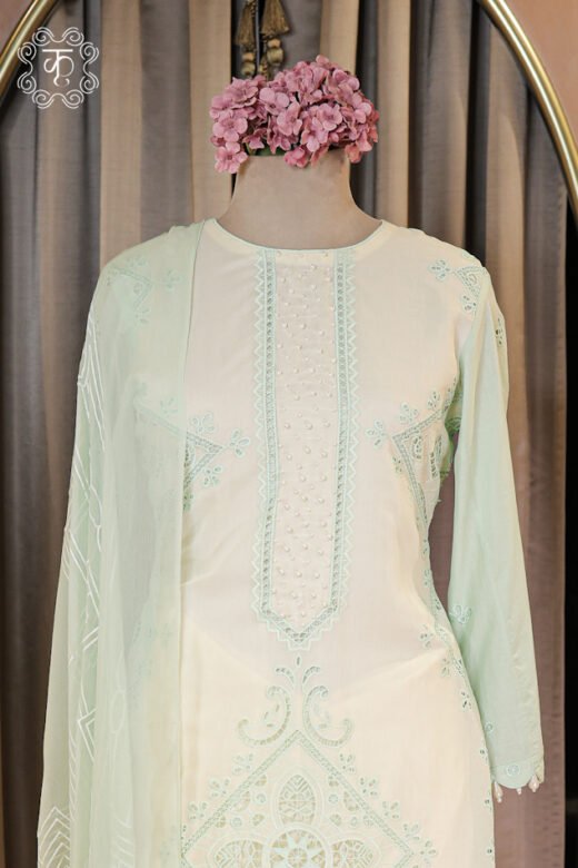 Close-up of the geometric cutwork embroidered motif and lace-trimmed hem on the Embroidered Cutwork and Pearl Work Suit Set tunic.