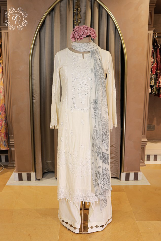 Close-up of the tone-on-tone chikankari embroidery and pearl drop tassel hem on the Embroidered Chikankari and Schiffli Cutwork Suit Set tunic.