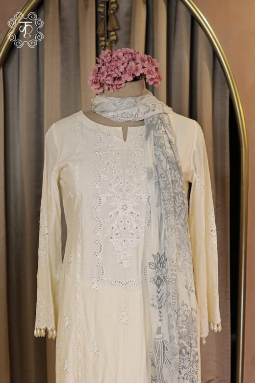 Close-up of the notched round neck and schiffli cutwork thread embroidery on the Embroidered Chikankari and Schiffli Cutwork Suit Set.