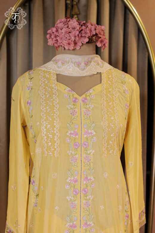 Close-up of the pink floral embroidery motifs and cutwork lace border on the hem of the Floral Thread Embroidered Chikankari and Lace Border Suit Set tunic.