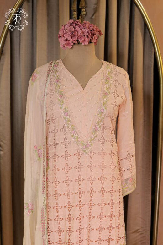 Close-up of the geometric schiffli cutwork pattern and scalloped embroidered floral hem on the All-Over Schiffli Cutwork and Pearl Embellished V-Neck Suit Set tunic.