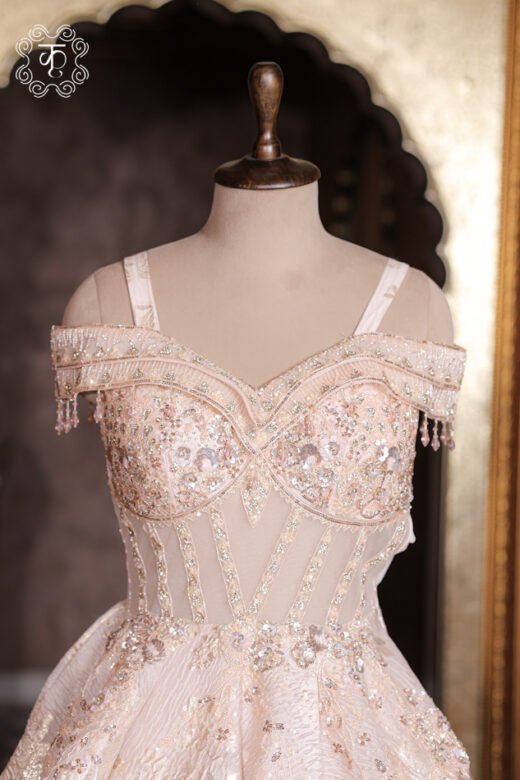 Close-up of the structured cap sleeve and dangling bead fringe tassels on the Embellished Sweetheart Corset Ball Gown.