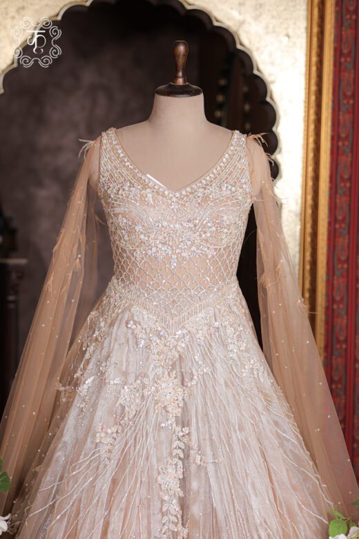Crystal Sequined Heavy Hand-Embroidered Ball Gown featuring a crystal bodice, feather cape sleeves, and a grand flared skirt from Kridhaa.