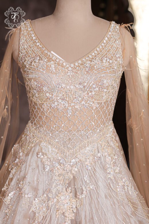 Close-up of the shoulder feather accents and floor-sweeping sheer cape sleeves on the Crystal Sequined Heavy Hand-Embroidered Ball Gown.