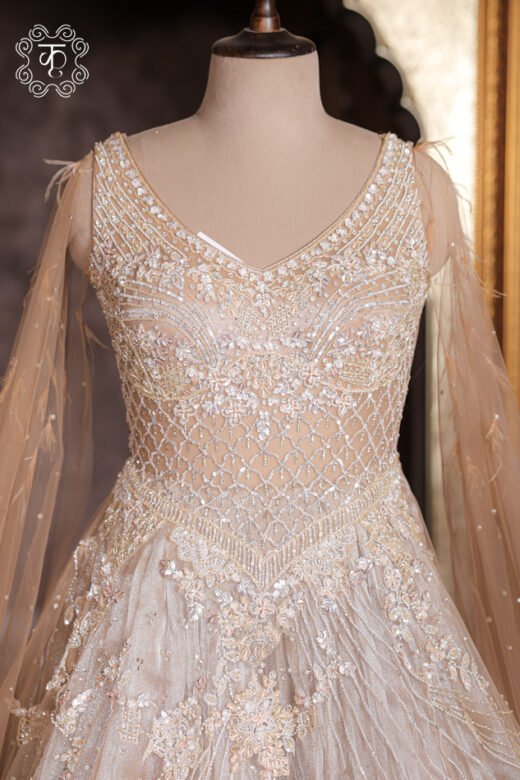 Detailed view of the cascading floral vine embroidery and shimmer lines on the skirt of the Crystal Sequined Heavy Hand-Embroidered Ball Gown.