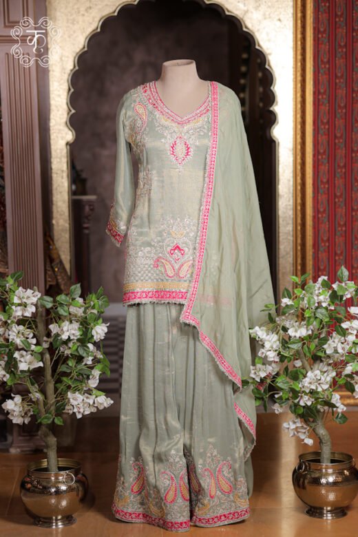Complete silhouette of the Embellished Paisley Zardozi Work Tissue Silk Short Kurta Sharara Set displaying the tunic and wide sharara flare from Kridhaa.