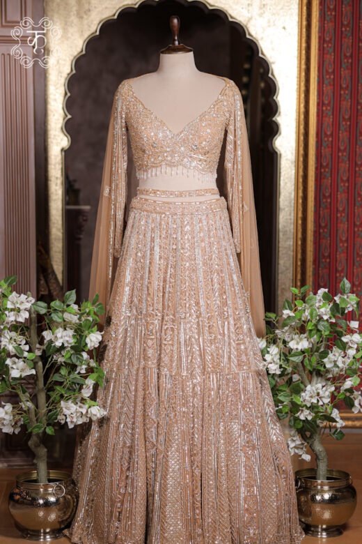Close-up of the embroidered waistband accent and floor-length sheer cape sleeve drape on the Geometrical Embroidered Sweetheart Blouse Lehenga Set.