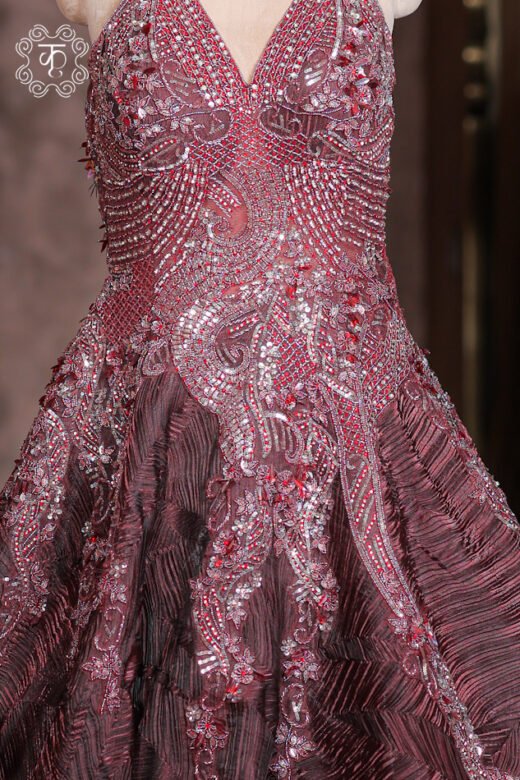 Detailed view of the structured crinkled geometric fabric pattern and skirt flare of the Halter-Neck Heavy Cutdana Embroidered Structured Texture Ball Gown.