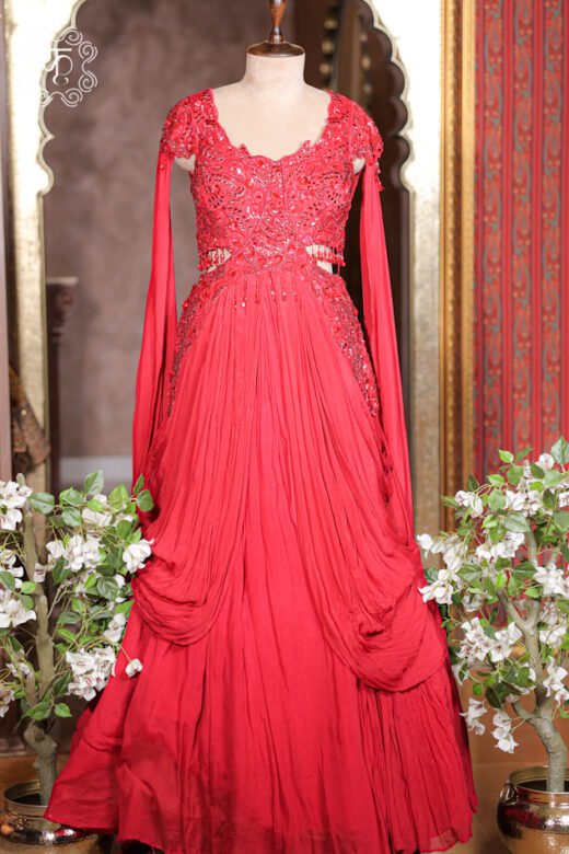 Embellished Cut-Out Waist Pre-Draped Gown featuring an embroidered bodice, floor-length cape sleeves, side cut-outs with bead tassels, and a pleated cowl skirt from Kridhaa.