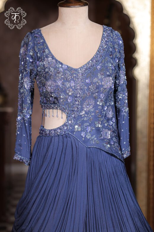 Detailed view of the crushed pleated cowl drape and flared skirt of the Sequined Cut-Out Waist Hand-Embroidered Pre-Draped Gown.