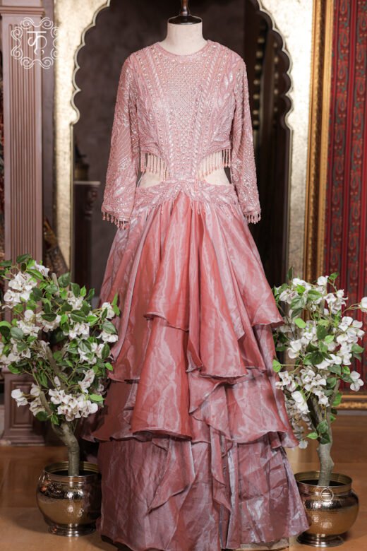 Close-up of the side waist cut-out with dangling glass bead fringe drops on the Cut-Out Waist Hand-Embroidered Organza Tiered Ruffle Gown.