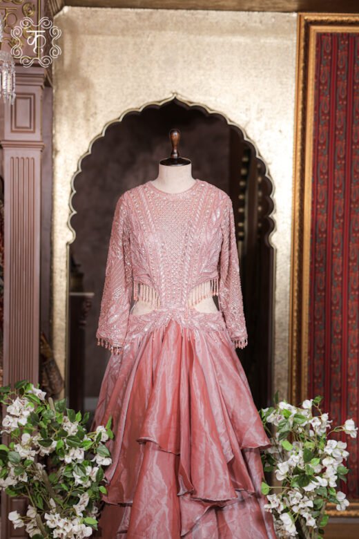 Complete floor-length silhouette of the Cut-Out Waist Hand-Embroidered Organza Tiered Ruffle Gown from Kridhaa.