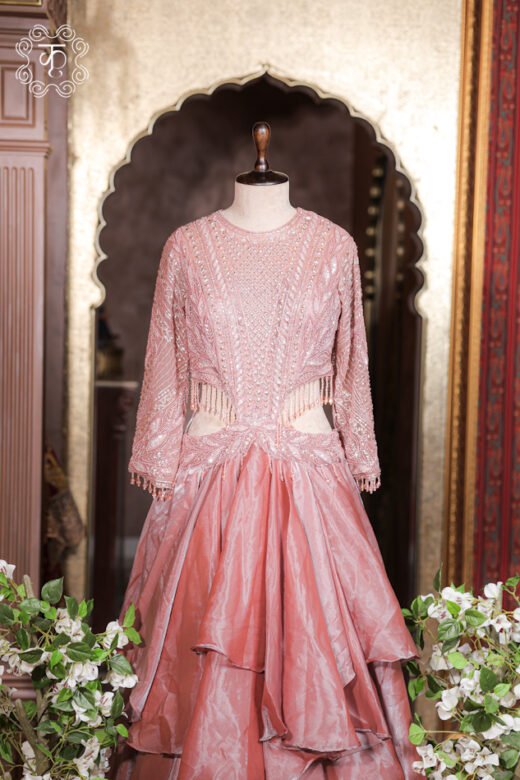 Detailed view of the multi-layered tissue organza tiered ruffles on the skirt of the Cut-Out Waist Hand-Embroidered Organza Tiered Ruffle Gown.
