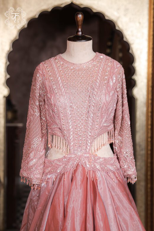 Close-up of the side waist cut-out with dangling glass bead fringe drops on the Cut-Out Waist Hand-Embroidered Organza Tiered Ruffle Gown.