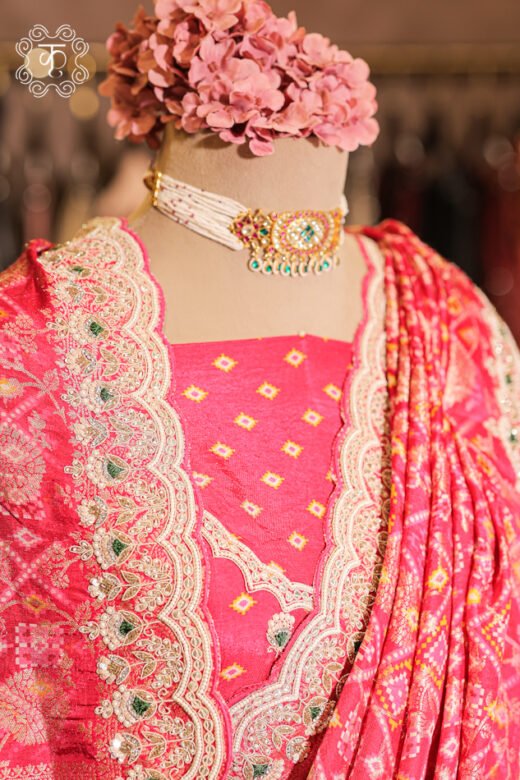 Close-up of the silver zardozi, sequins, pearls, and green stone accents on the scalloped border of the Bandhani Print Silk Saree.