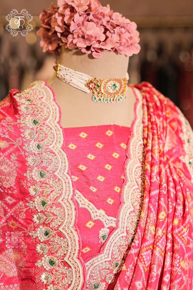 Close-up of the silver zardozi, sequins, pearls, and green stone accents on the scalloped border of the Bandhani Print Silk Saree.