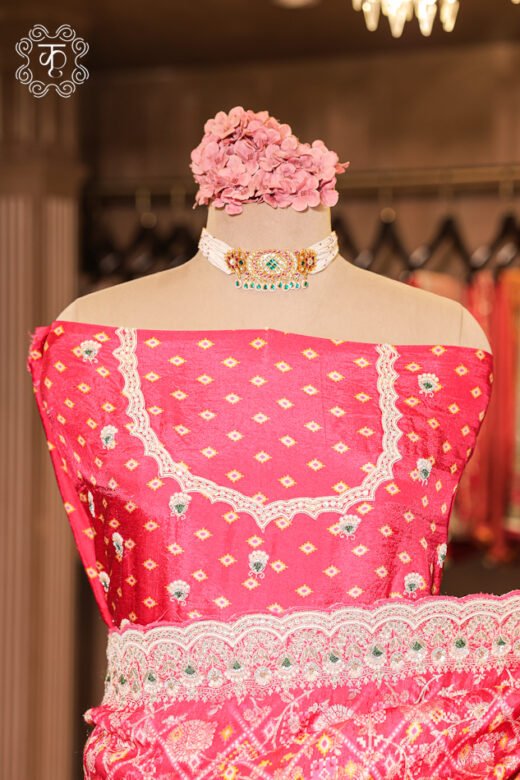 Detailed view of the woven silk blouse piece with fine booti work from the Bandhani Print Silk Saree.