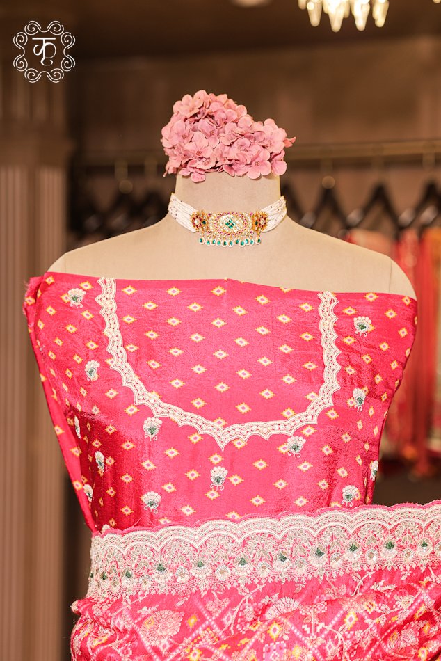 Detailed view of the woven silk blouse piece with fine booti work from the Bandhani Print Silk Saree.