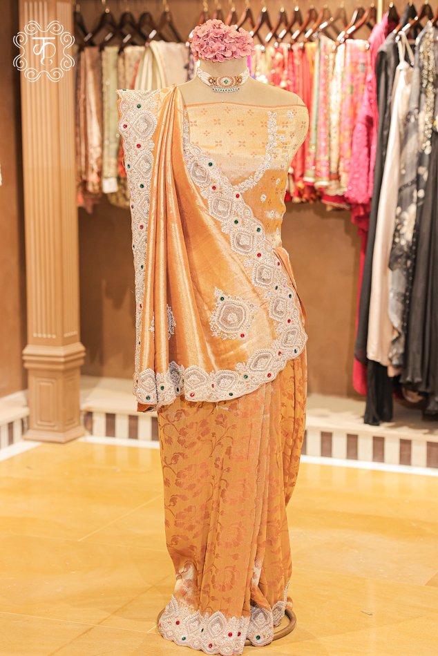 Banarasi Tissue Silk Floral Brocade Saree featuring a woven floral jaal body, pleated pallu drape, and a hand-embroidered scalloped zardozi border from Kridhaa.