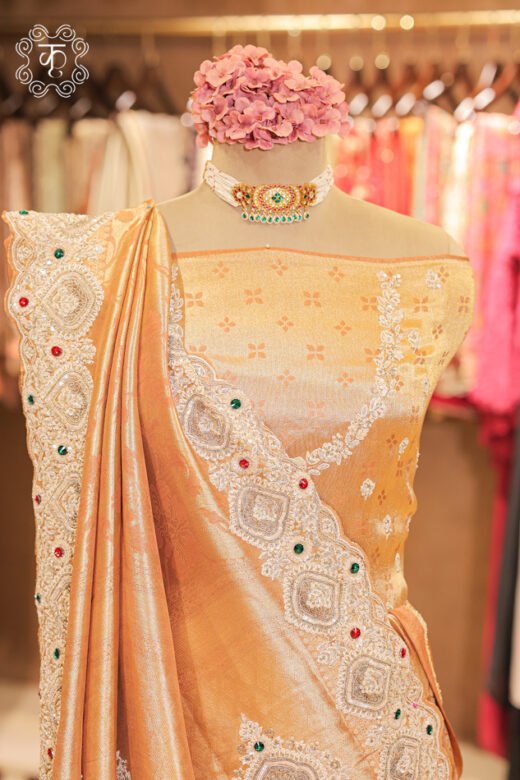 Detailed view of the woven tissue silk blouse piece with embroidered neckline trim from the Banarasi Tissue Silk Floral Brocade Saree.