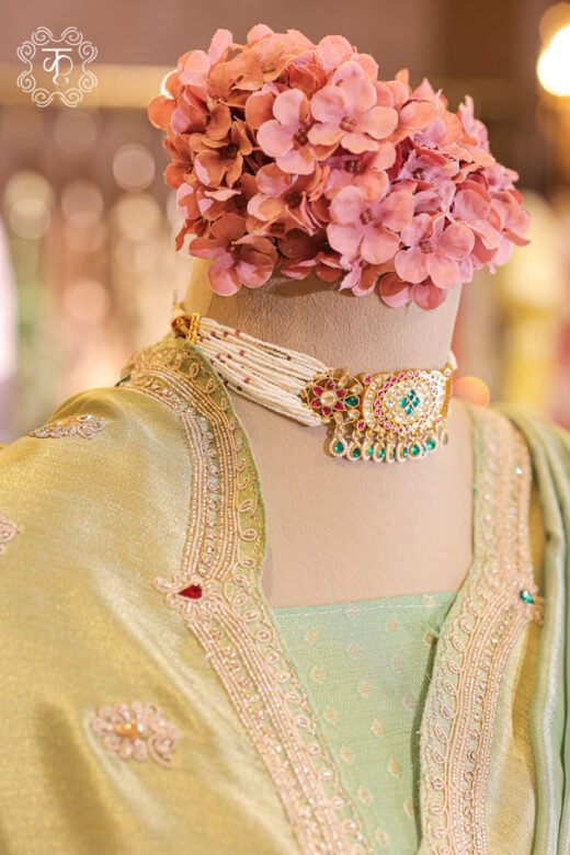 Detailed view of the woven tissue silk blouse piece with an embroidered neckline trim from the Dual-Tone Metallic Tissue Silk Saree.