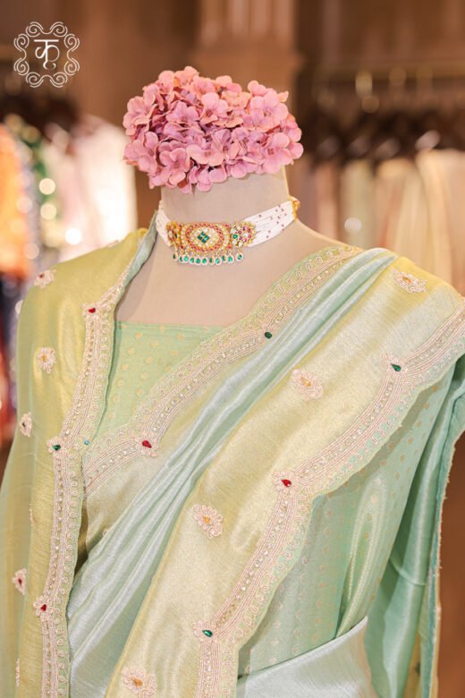Close-up of the silver zardozi, sequins, pearls, and gemstone accents on the scalloped border of the Dual-Tone Metallic Tissue Silk Saree.