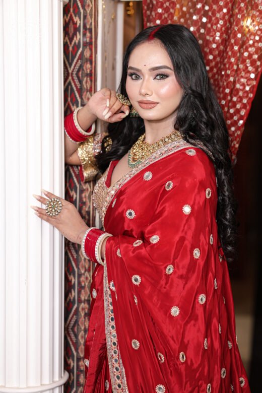 Detailed view of the heavily embroidered zardozi and mirror work blouse paired with the Silk Satin Saree with Mirror Work.