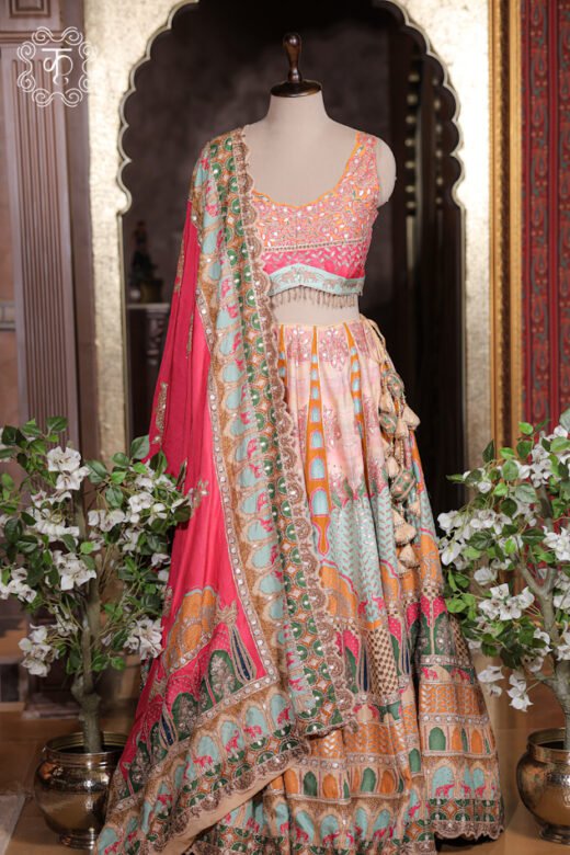 Detailed view of the embroidered scalloped border, mirror accents, and printed trim on the dupatta of the Printed Silk Lehenga Set.