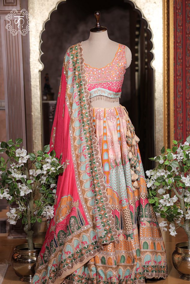 Detailed view of the embroidered scalloped border, mirror accents, and printed trim on the dupatta of the Printed Silk Lehenga Set.