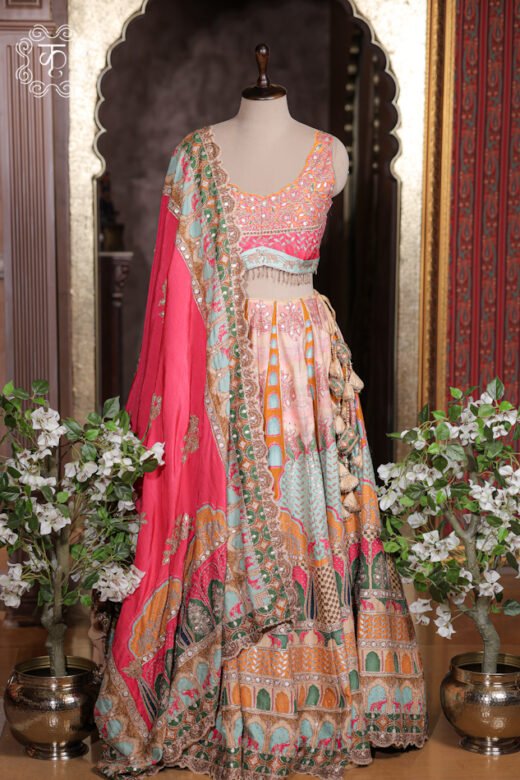 Printed Silk Lehenga Set featuring architectural jharokha prints, mirror work choli, fringed tassels, and a scalloped border dupatta from Kridhaa.