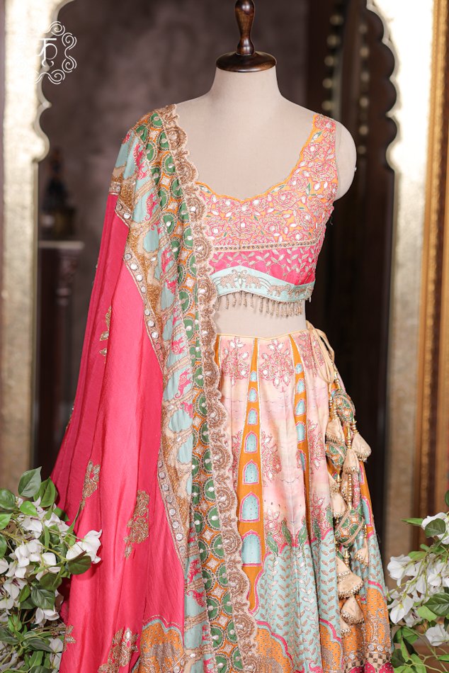 Close-up of the mirror work embroidery, gota patti work, and hanging bead tassels on the choli of the Printed Silk Lehenga Set.