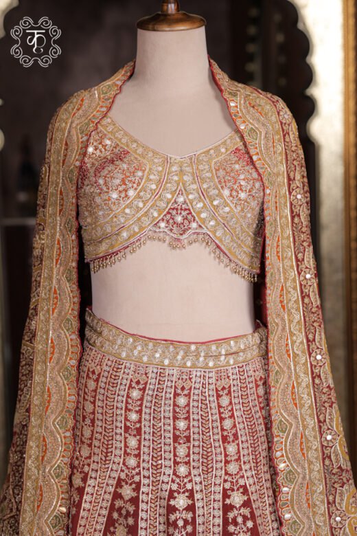 Close-up of the scalloped sweetheart neck, mirror-work zardozi embroidery, and hanging bead tassels on the choli of the Embroidered Georgette Lehenga Set.