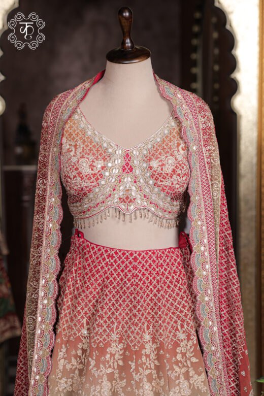 Close-up of the scalloped sweetheart neck, mirror-work zardozi embroidery, and hanging bead tassels on the choli of the Ombre Georgette Lehenga Set.