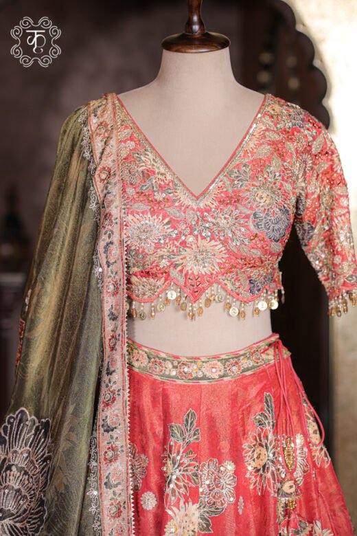 Side angle profile of flared coral red silk lehenga skirt showcasing structure and volume.