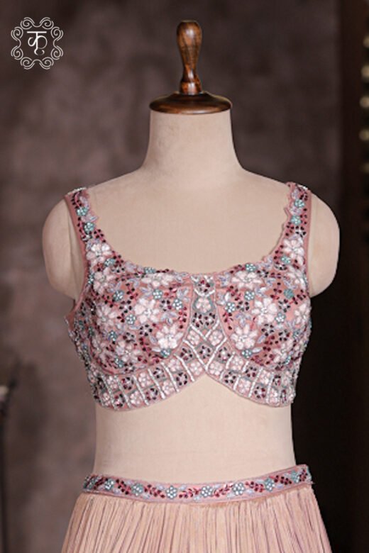 Micro crush pleat fabric detail of dusty rose georgette lehenga skirt with embroidered waistband.