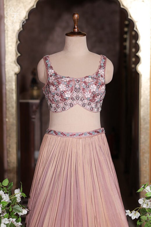 Side profile view of flared dusty rose crushed georgette lehenga skirt showing fluid movement.