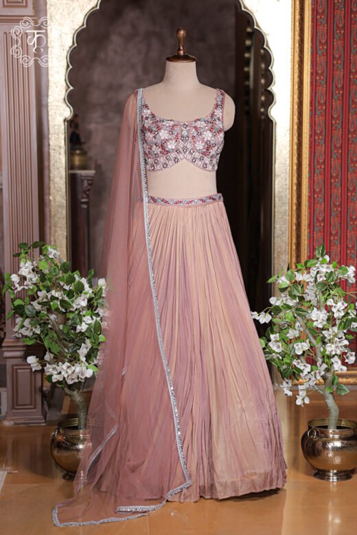 Dusty rose pink crush pleated georgette lehenga set with floral embroidered sleeveless sweetheart blouse.