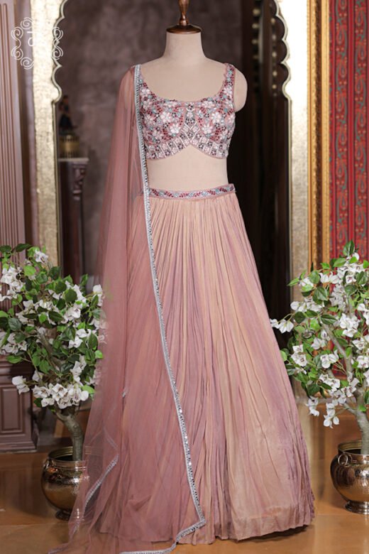 Close up of dusty rose sleeveless sweetheart blouse with floral embroidery, sequin work, and beads.