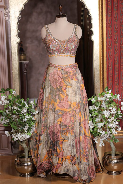 Detailed print texture of mustard yellow silk lehenga skirt with rose botanical print and embroidered waistband.